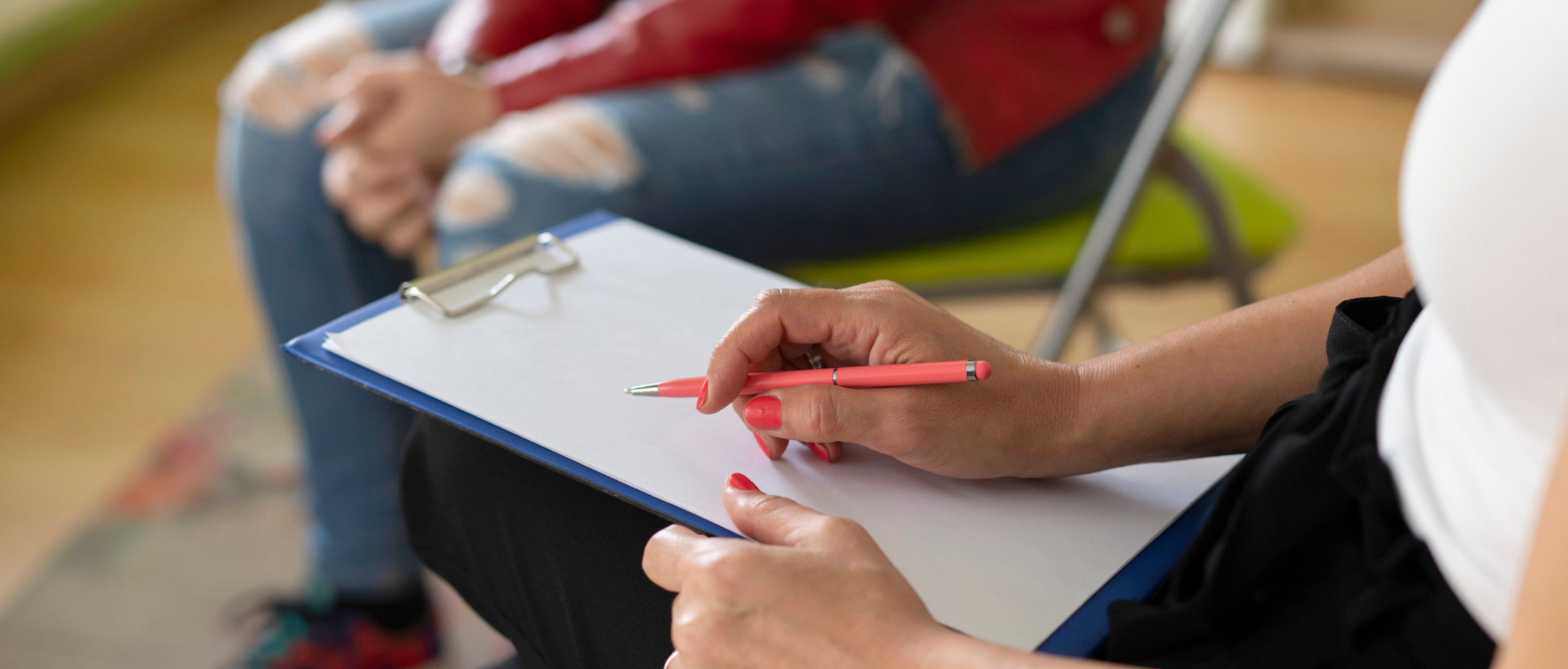 Person writing on clip board