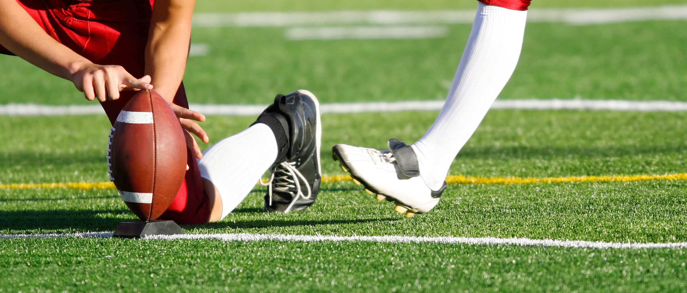 Football player kicking the football