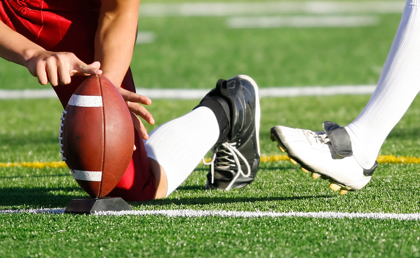 Football player kicking a football